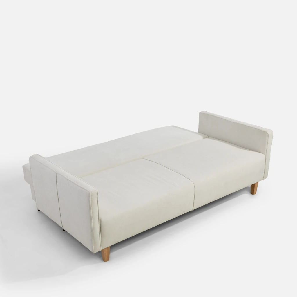 Jasnobeżowa sofa po rozłożeniu. Powierzchnia spania to 138x197 cm.