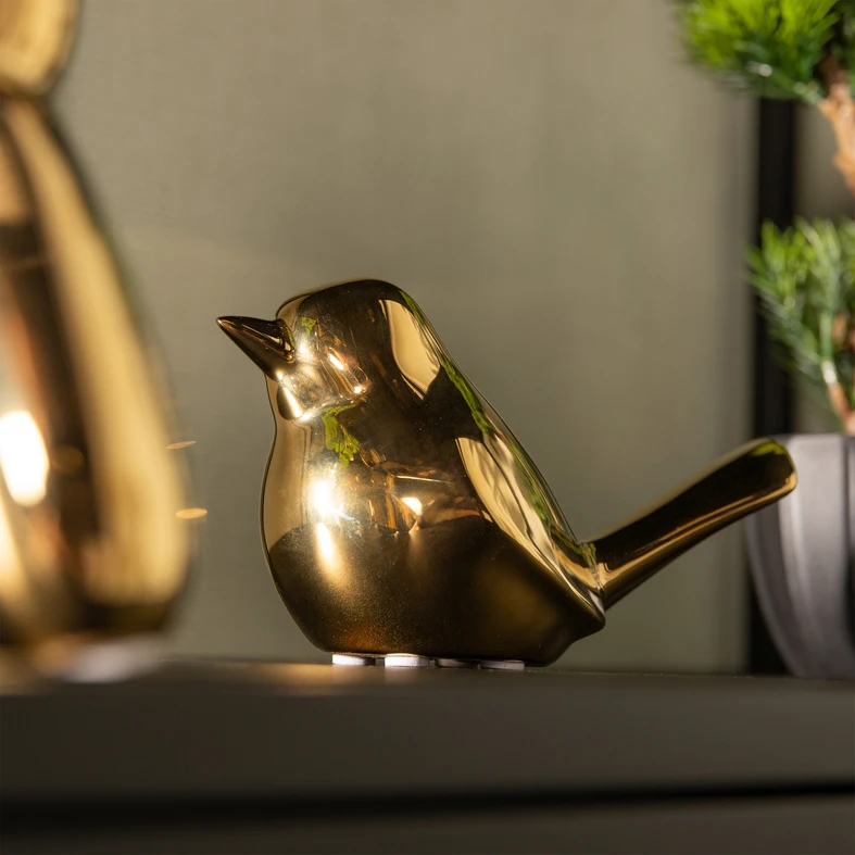 Złota figurka w kształcie ptaka z kamionki