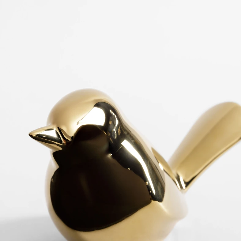 Złota figurka w kształcie ptaka z kamionki