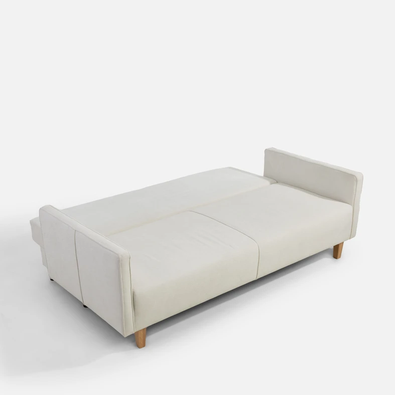 Jasnobeżowa sofa po rozłożeniu. Powierzchnia spania to 138x197 cm.